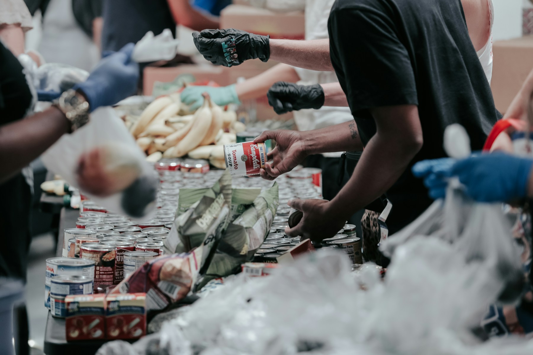 Volunteers sorting canned food at a community drive