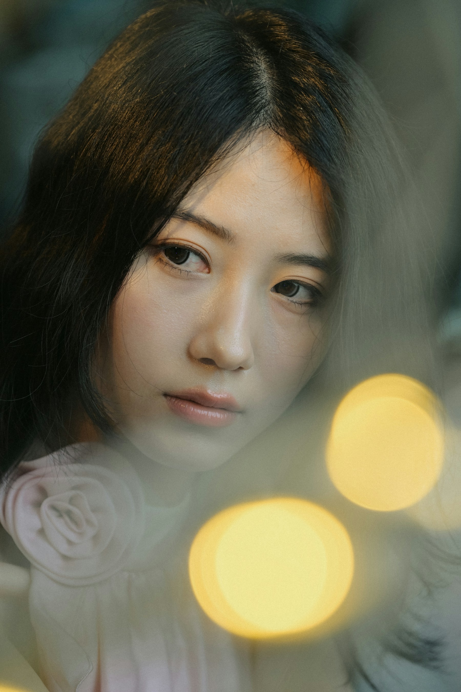 Editorial portrait of a woman in a cream suit with a red flower